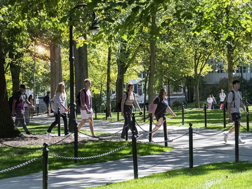 Students walking on campus on a sunny day.